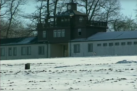 Screenshot from a film. The picture shows the roll call area and the camp gate. 