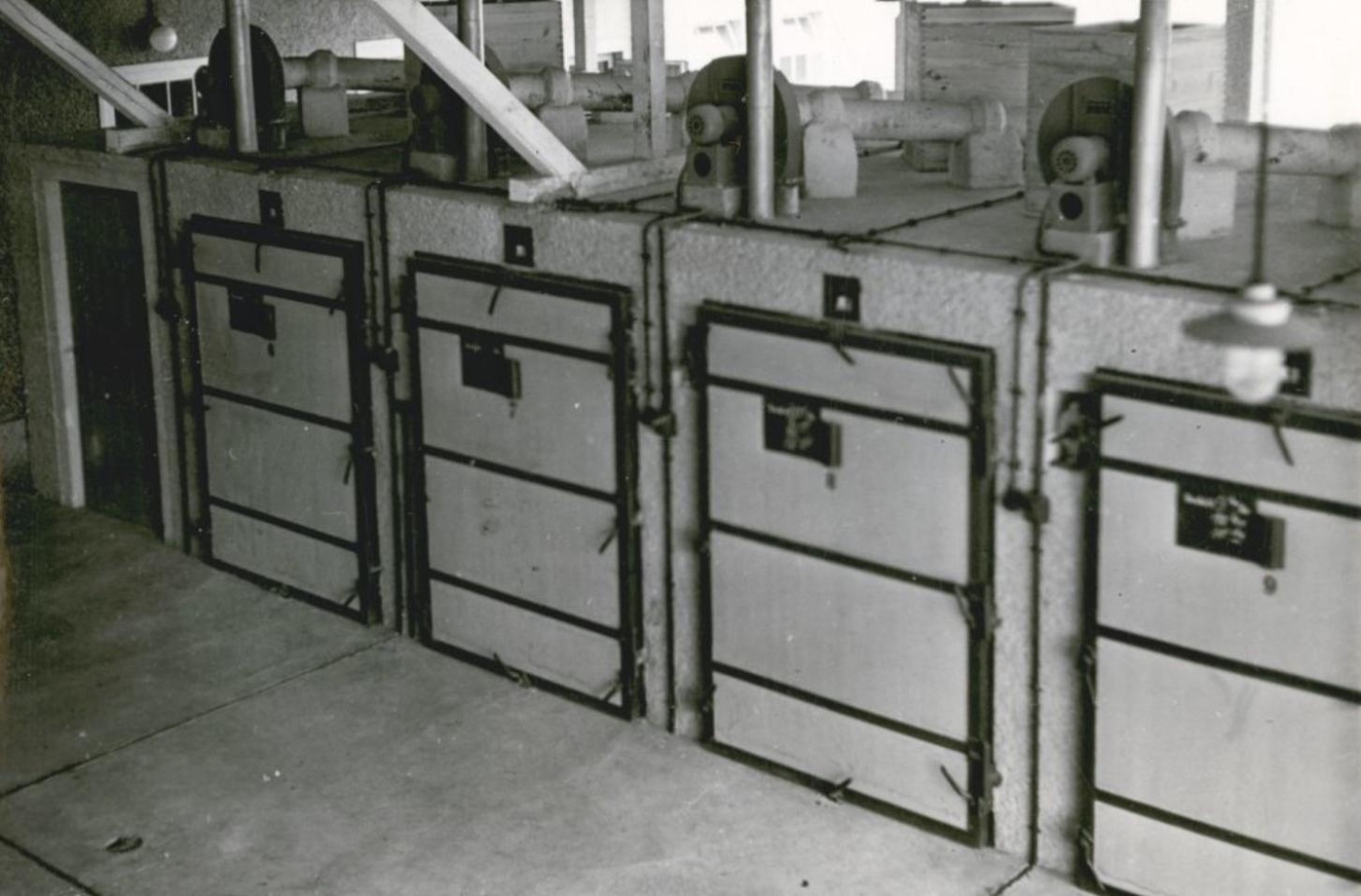 Four boxes with lockable doors can be seen next to each other. Pipes are fed to the boxes.