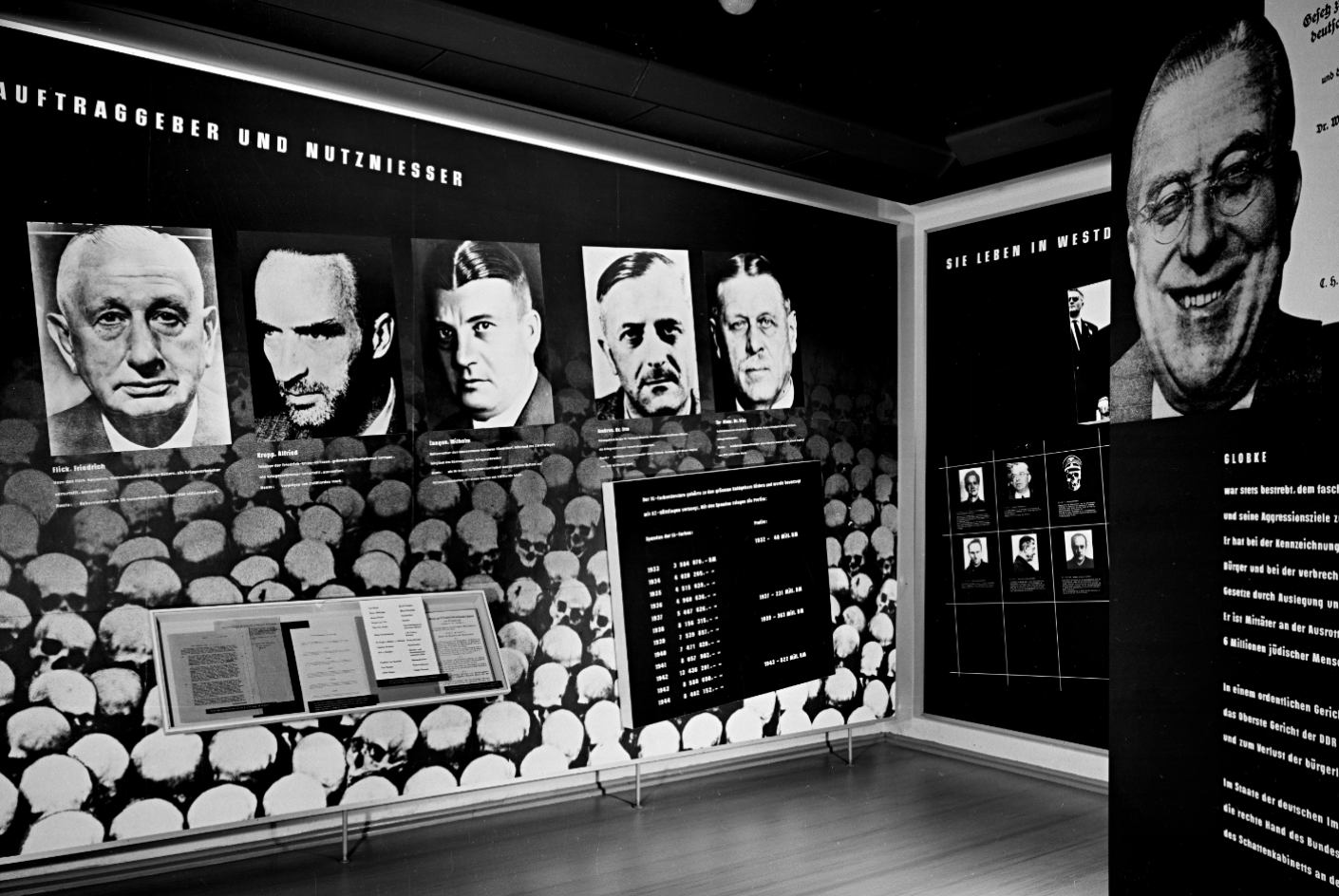 The picture shows one of the old exhibition rooms in the former disinfection. The room deals with clients and profiteers of the concentration camp Buchenwald. On the far right is a photo of the broadly grinning Hanz Globke, who at the time of the exhibition opening was Secretary of State of the FRG under Konrad Adenauer. On the left are photographs of 5 other people. The captions reveal that they are Friedrisch Flick, Alfried Krupp, Wilhelm Zangen, Dr. Otto Ambross and Dr. Fritz Ter Meer.The picture shows one of the old exhibition rooms in the former disinfection. The room deals with clients and profiteers of the concentration camp Buchenwald. On the far right is a photo of the broadly grinning Hanz Globke, who at the time of the exhibition opening was Secretary of State of the FRG under Konrad Adenauer. On the left are photographs of 5 other people. The captions reveal that they are Friedrisch Flick, Alfried Krupp, Wilhelm Zangen, Dr. Otto Ambross and Dr. Fritz Ter Meer.