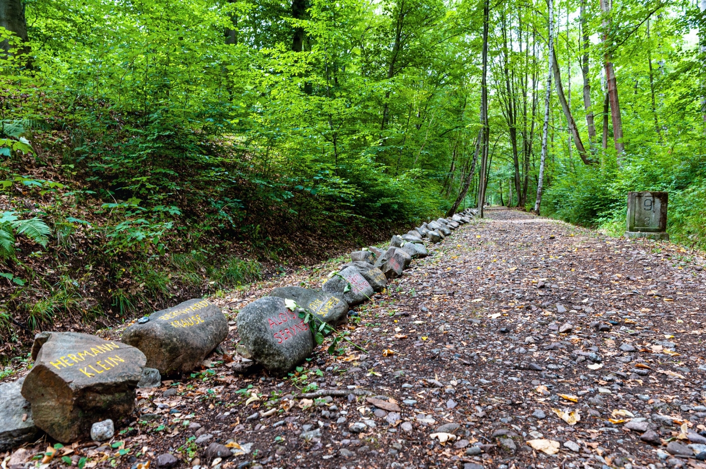 A section of the Buchenwaldbahn memorial path. Along the path are engraved or painted stones with the names of the deported children. On the right in the picture one of the milestones of the former railroad line.