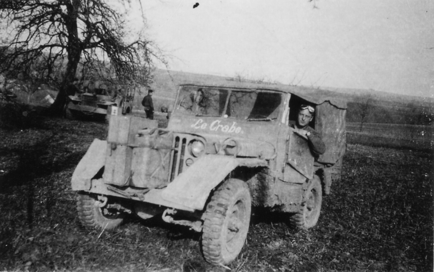 A Jeep, which was marked below the windshield with the lettering "Le Crabe". Bezin canisters and toolboxes were attached to the Jeep's radiator. Paul Bodot looks out of the side window.