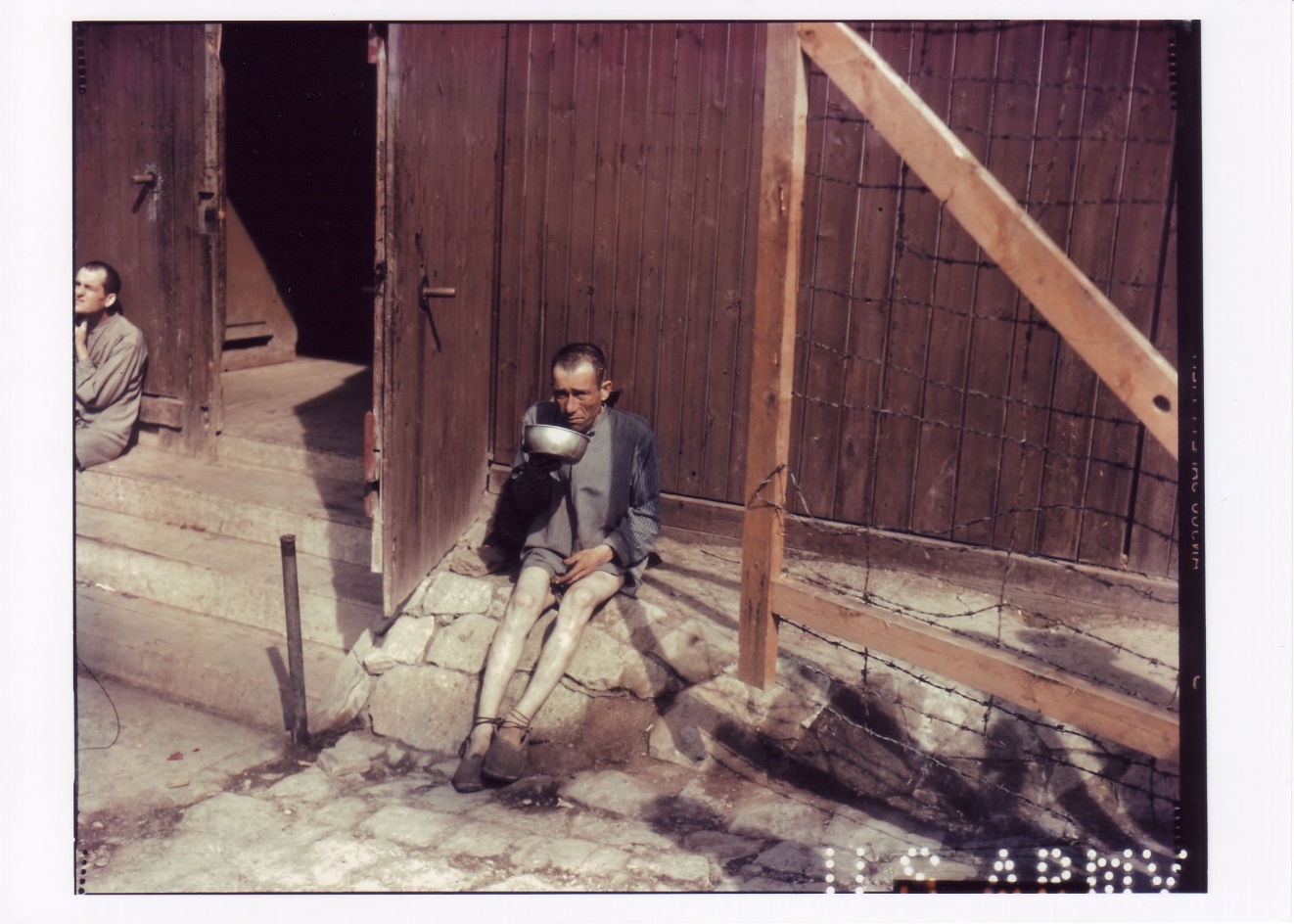 Prisoner with a food bowl in front of Block 55 in the Small Camp.