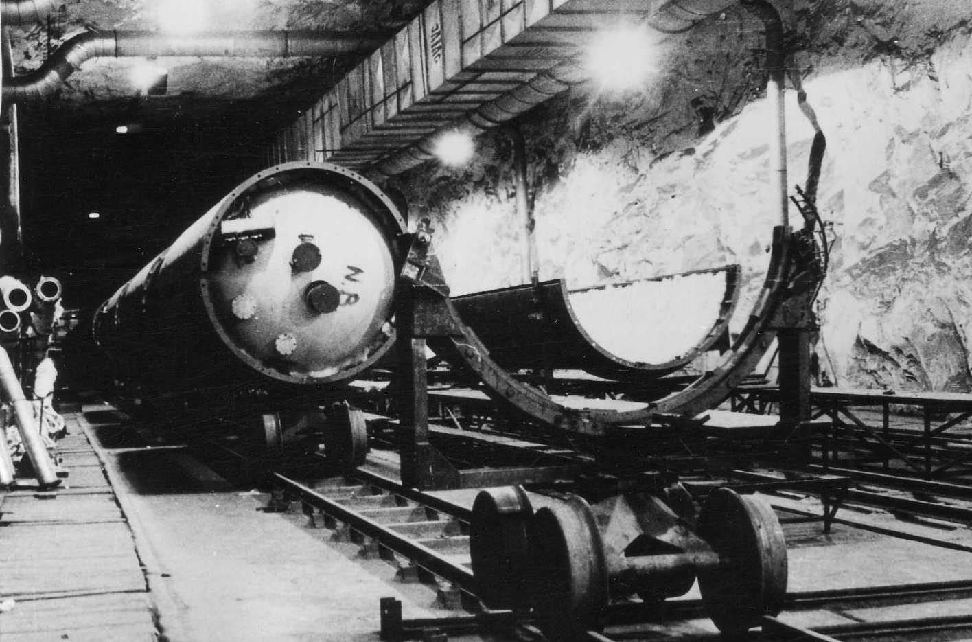 A partially assembled A4(V2) rocket on a trolley on rails in one of the Mittelwerk tunnels.