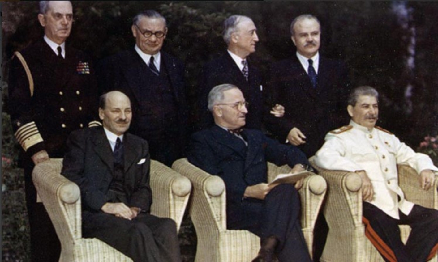 Clement Attlee, Harry S. Truman und Josef Stalin sitzen in Korbstühlen. Hinter ihnen stehen ihre jeweiligen Außenminister.