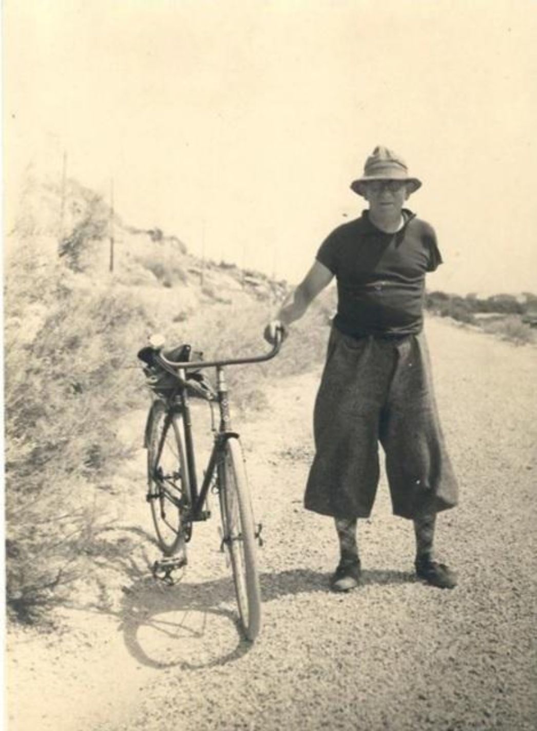 André Bach on a country road with a bicycle. 