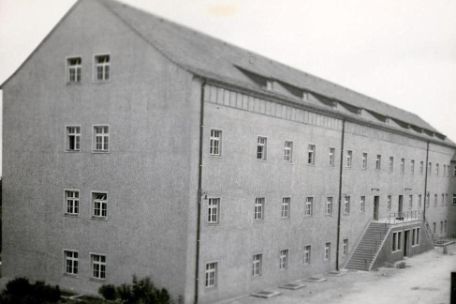 Exterior view of the chamber building. The building is, long, has three floors with small windows, and a high gable roof. On the right side of the picture a double-sided staircase marks the entrance to the building