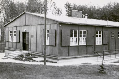 View of the so-called Sonderbau, a simple wooden barracks in which the SS had set up the camp brothel. From the inside, curtains are halfway up the windows. 
