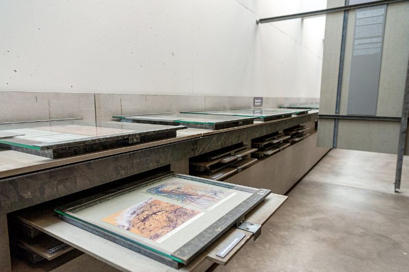 Drawings under glass panels that can be pulled out. 