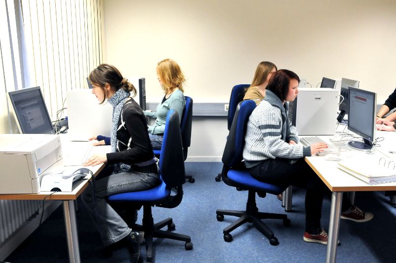 Several young people using the computers in the memorial's PC pool.