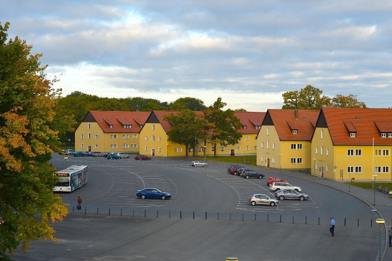 The semicircular parking lot with four oblong buildings.